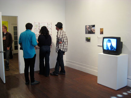 invsoc04a Photographer Seth Lower (far left, sethlower.com) inspects This and That; Jeronimo Roldan and Marcella Faustini and friend inspect Amanda Curreri's/Sally Elesby's correspondence (center). Jessica William's art (right). Not pictured: David Horvitz' letters about the Indian Ocean.