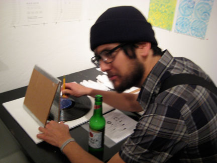 tnt13 Joshua Churchill, looking uncharacteristically dodgy, powers N. Sean Glover's cardboard record player.