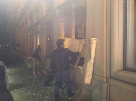 Adam Gabbat for the Guardian: "10.33am GMT: Some of the Occupy protesters have been repairing the damage done by a small group of people who did employ violence." Posted about 30 minutes after another posting about the "third use of tear gas," presumably the haze in the photo? (Photo: Adam Gabbatt; source: Guardian.co.uk.)