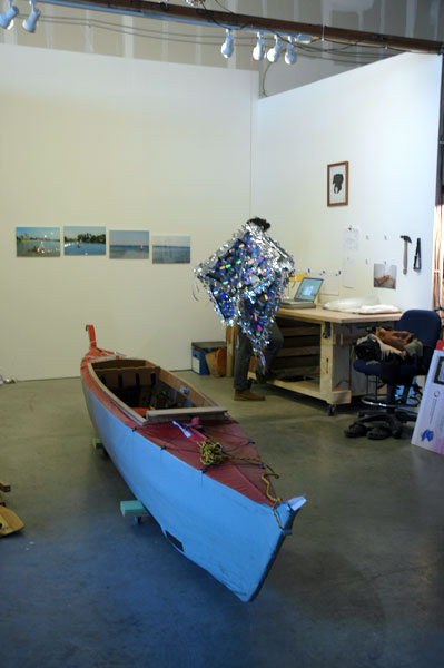 Studio visit with Michael Arcega. Baby, the artist-designed and -made collapsible, outrigger canoe, under a pinata-disco ball-hybrid. Not to mention an envy-inspiring woodshop in the studio.