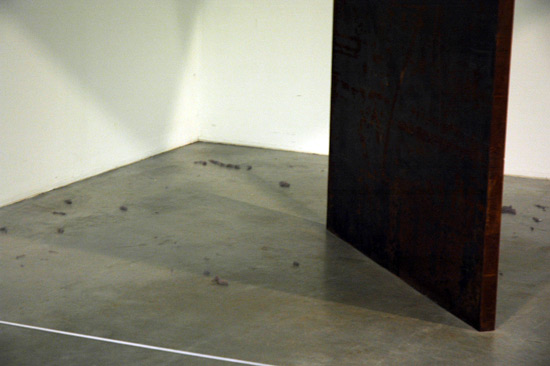 Dust bunnies under a Richard Serra sculpture at the Tate Modern. Good decision to leave it as is. Would you want to sweep under a massive sheet of steel that is not fastened to anything? 