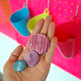 Christine Wong Yap, Irrational Exuberance (Asst. Colors) buttons #1–3, 2010, badges, 1–1.75 inches / 2.5 x 4.5 cm dia. each.