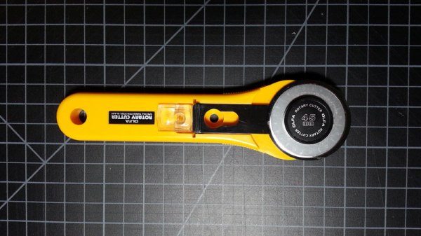 Mirror hanger in rotary cutter. Locks blade cover in place for transport.