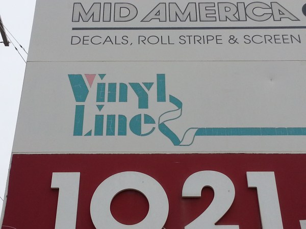 Avant Garde outline above aqua and pink stencil with ribbon.