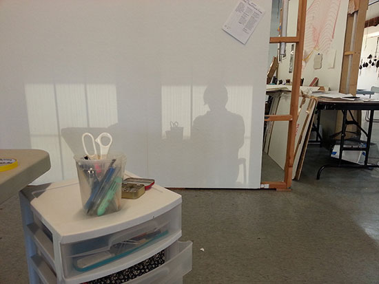 My silhouette on my studio wall, formed in sunset light reflected from skyscrapers.