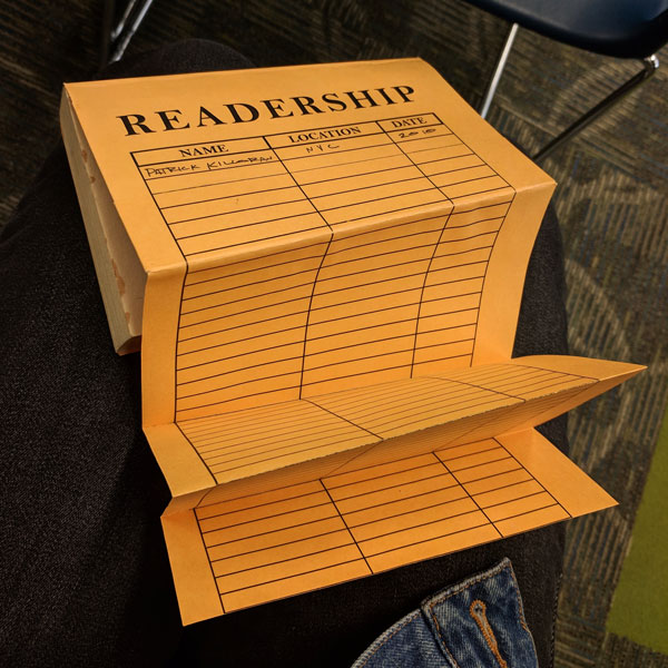 A book with a fold-out back cover. It looks like an inter-office envelope, but the top says "readership," and the table headers say, "Name, location, date."