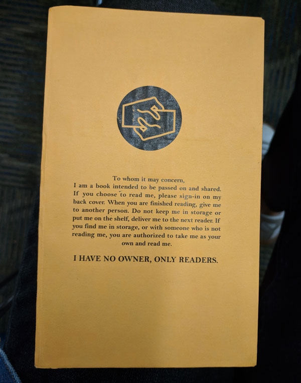 The new book cover reads, "To whom it may concern, I am a book intended to be passed on and shared. If you choose to read me, please sign-in on my back cover. When you are finished reading, give me to another person. Do not keep me in storage or put me on the shelf, deliver me to the next reader. If you find me in storage, or with someone who is not reading me, you are authorized to take me as your own and read me. I HAVE NO OWNER, ONLY READERS."