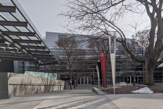 Entry way to the museum, with a long path framed by bare winter trees.